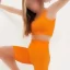 ست نیم تنه و شلوارک ورزشی زنانه طرح کبریتی لی‌لی رنگ نارنجی